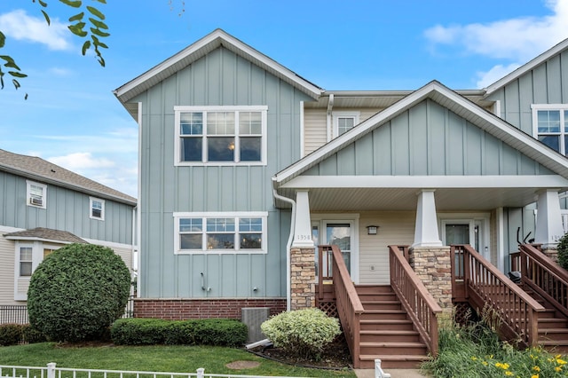 1358 Phalen Blvd, Saint Paul, MN 55106 - view of front of property with board and batten siding, covered porch, and stairway