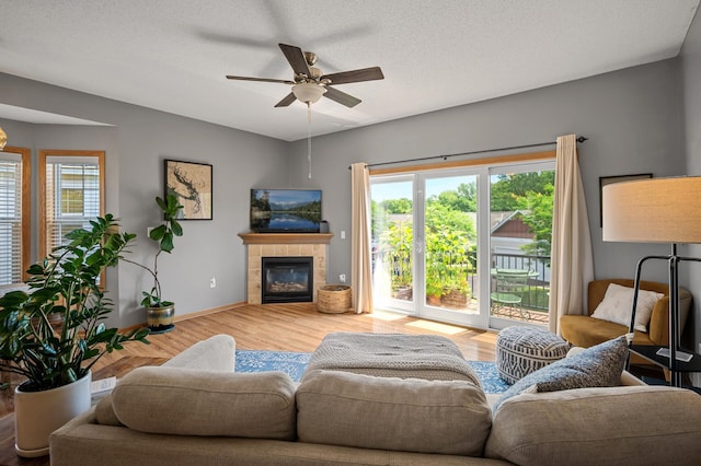 1358 Phalen Blvd, Saint Paul, MN 55106 - living area with wood finished floors, ceiling fan, and a tile fireplace