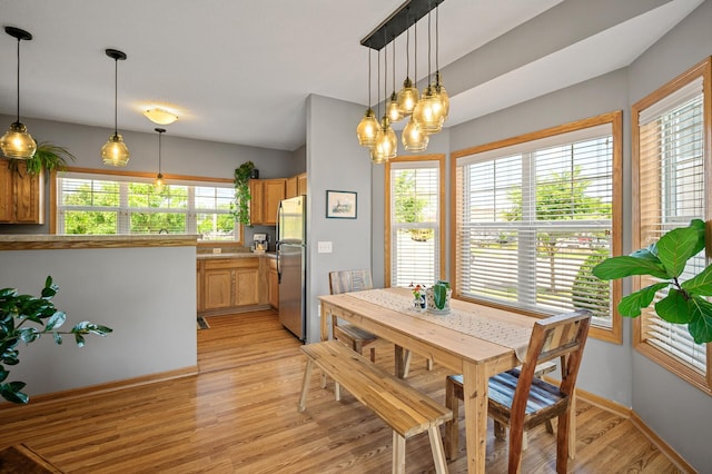 1358 Phalen Blvd, Saint Paul, MN 55106 - dining area featuring light wood-style flooring, healthy amount of natural light, and a chandelier