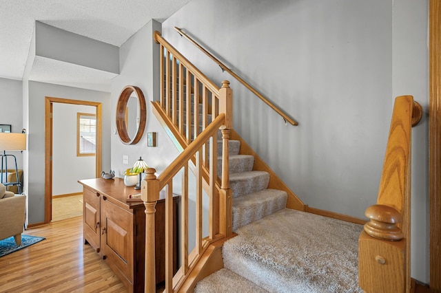 1358 Phalen Blvd, Saint Paul, MN 55106 - stairway featuring wood finished floors and a textured ceiling