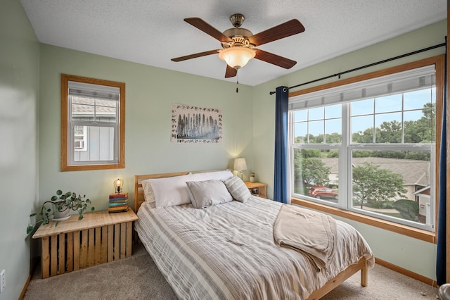1358 Phalen Blvd, Saint Paul, MN 55106 - carpeted bedroom featuring multiple windows, a ceiling fan, and a textured ceiling