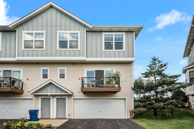 1358 Phalen Blvd, Saint Paul, MN 55106 - townhome / multi-family property featuring board and batten siding, an attached garage, a balcony, and driveway