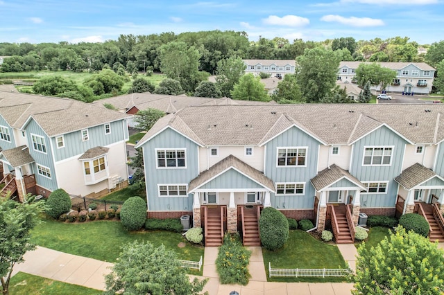 1358 Phalen Blvd, Saint Paul, MN 55106 - view of front of home featuring stairway, board and batten siding, a residential view, and roof with shingles