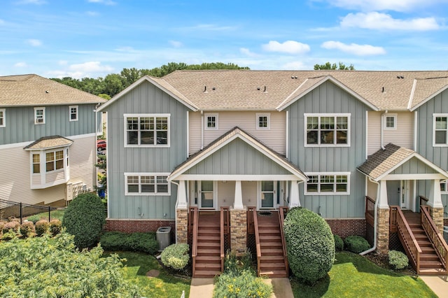 1358 Phalen Blvd, Saint Paul, MN 55106 - view of front facade featuring stairway, board and batten siding, covered porch, and roof with shingles