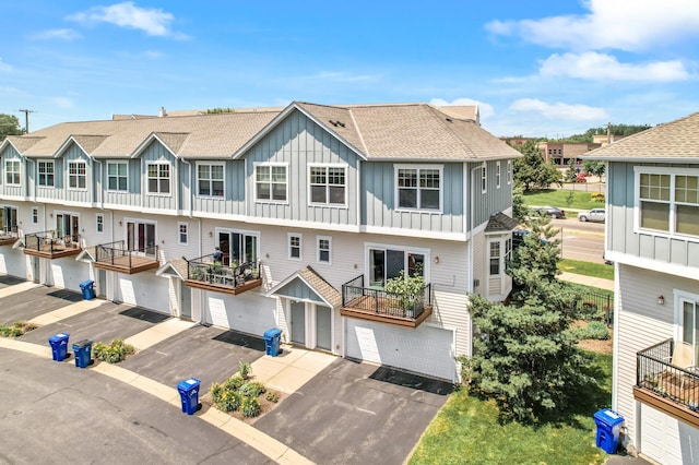 1358 Phalen Blvd, Saint Paul, MN 55106 - multi unit property with board and batten siding, driveway, a shingled roof, and a residential view
