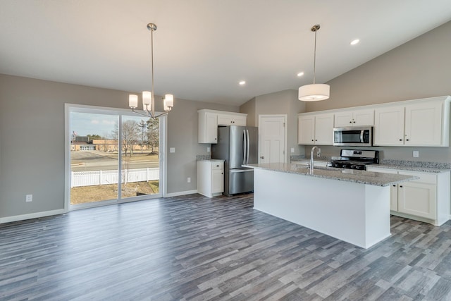 625 47th Ave NE, Saint Cloud, MN 56304 - kitchen featuring stainless steel appliances, wood finished floors, vaulted ceiling, white cabinets, and an island with sink