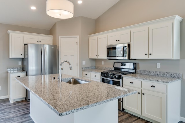 625 47th Ave NE, Saint Cloud, MN 56304 - kitchen featuring stainless steel appliances, dark wood-type flooring, white cabinetry, light stone countertops, and a center island with sink