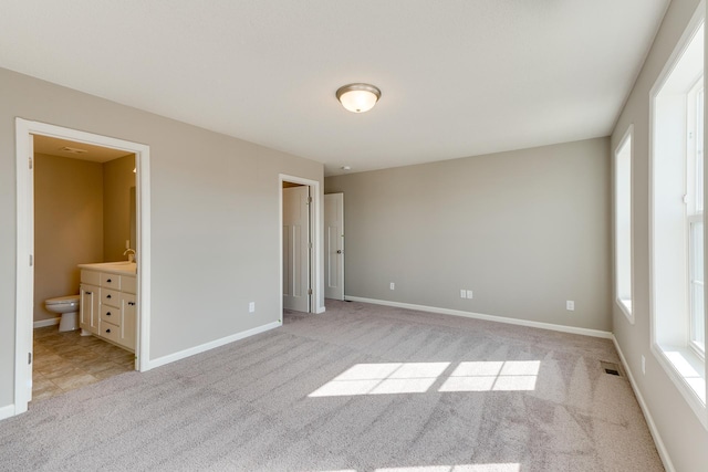 625 47th Ave NE, Saint Cloud, MN 56304 - unfurnished bedroom with light carpet and connected bathroom
