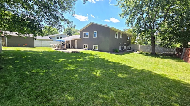 1515 3rd Ave NE, Owatonna, MN 55060 - back of house with a patio, a fenced backyard, and stucco siding