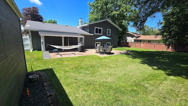 1515 3rd Ave NE, Owatonna, MN 55060 - back of house featuring a fenced backyard, a patio, and a chimney
