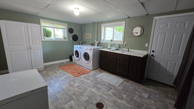 1515 3rd Ave NE, Owatonna, MN 55060 - laundry area with cabinet space, washer and dryer, healthy amount of natural light, and stone finish floors