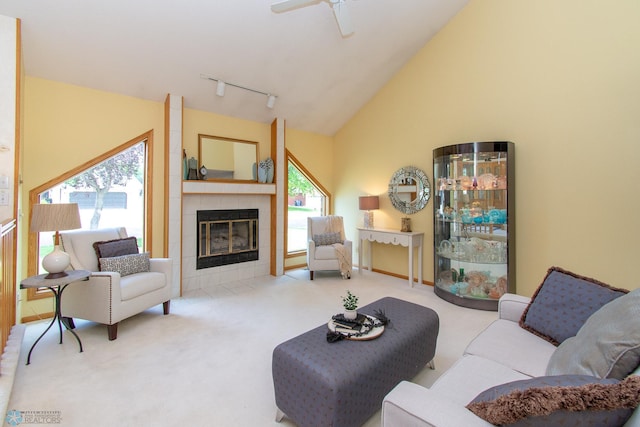 2902 24th Ave S, Fargo, ND 58103 - living room with carpet, rail lighting, a tile fireplace, vaulted ceiling, and ceiling fan