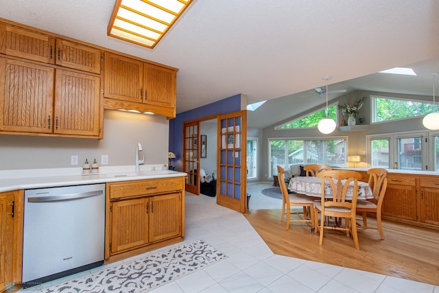 2902 24th Ave S, Fargo, ND 58103 - kitchen featuring dishwasher, a skylight, plenty of natural light, vaulted ceiling, and light countertops
