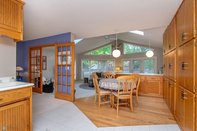 2902 24th Ave S, Fargo, ND 58103 - dining room featuring french doors, lofted ceiling, and light tile patterned floors