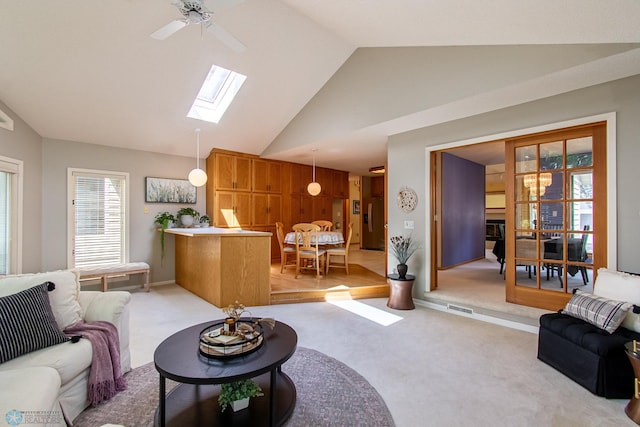 2902 24th Ave S, Fargo, ND 58103 - living area with lofted ceiling, light carpet, a skylight, and ceiling fan