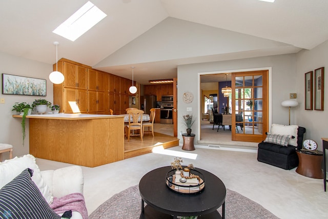 2902 24th Ave S, Fargo, ND 58103 - living room with light carpet, a skylight, and high vaulted ceiling