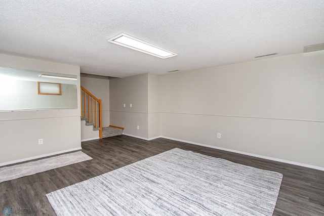 2902 24th Ave S, Fargo, ND 58103 - finished below grade area featuring dark wood finished floors, a textured ceiling, and stairs