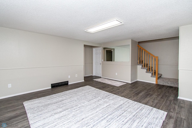 2902 24th Ave S, Fargo, ND 58103 - empty room featuring dark wood-style floors, a textured ceiling, and stairway