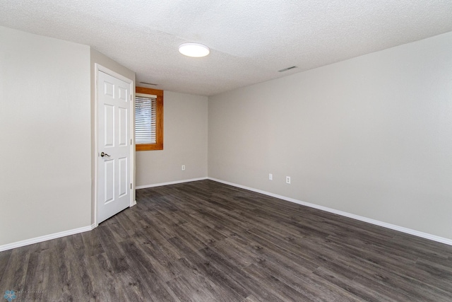 2902 24th Ave S, Fargo, ND 58103 - spare room featuring dark wood-style flooring and a textured ceiling