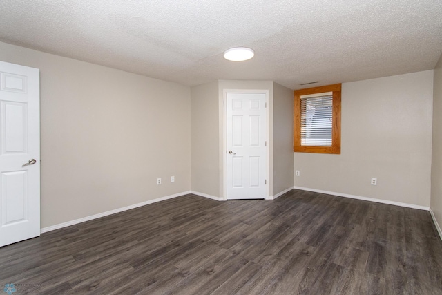 2902 24th Ave S, Fargo, ND 58103 - unfurnished room with dark wood-style flooring and a textured ceiling