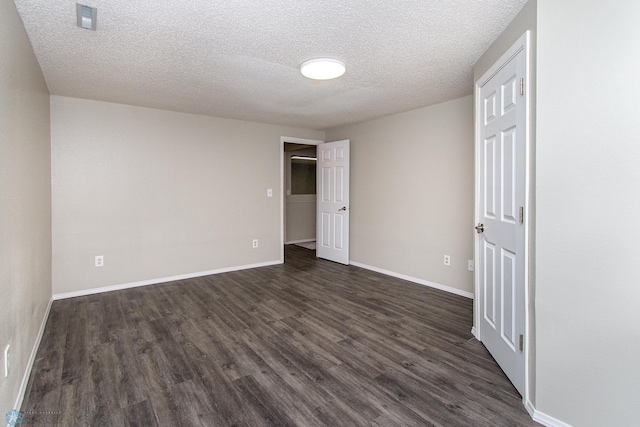 2902 24th Ave S, Fargo, ND 58103 - empty room with dark wood-style floors and a textured ceiling