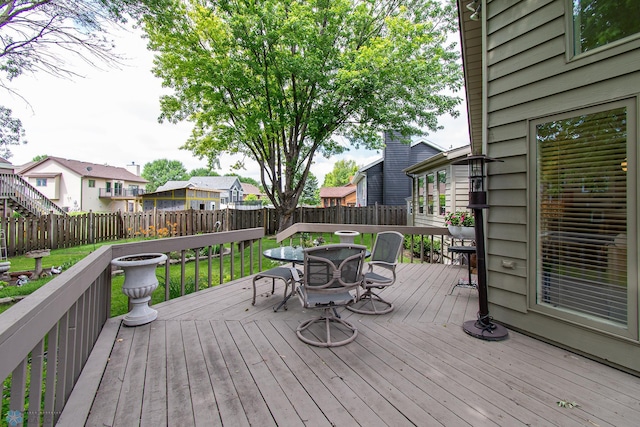 2902 24th Ave S, Fargo, ND 58103 - wooden terrace featuring outdoor dining area, a fenced backyard, and a residential view