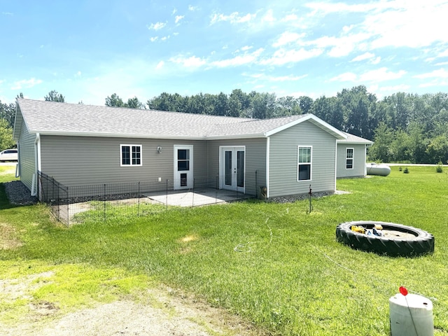 46313 St Lawrence Dr, Otto Twp, MN 56573 - back of house with french doors, a patio, a yard, and a shingled roof