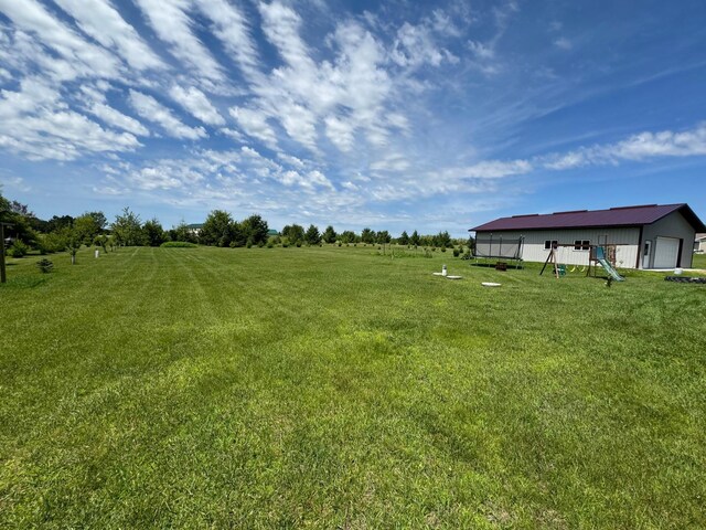 46313 St Lawrence Dr, Otto Twp, MN 56573 - view of green lawn with a garage