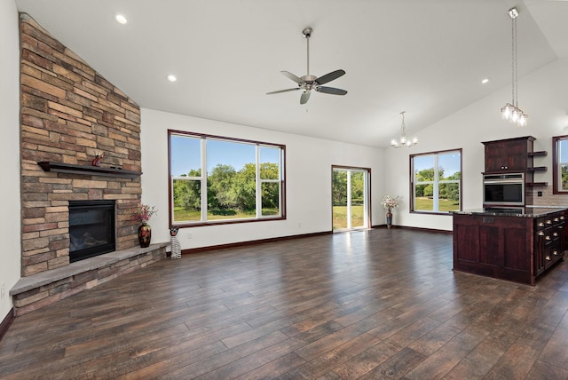 11039 285th Ave, Zimmerman, MN 55398 - unfurnished living room with a stone fireplace, high vaulted ceiling, a chandelier, a ceiling fan, and dark wood-style floors