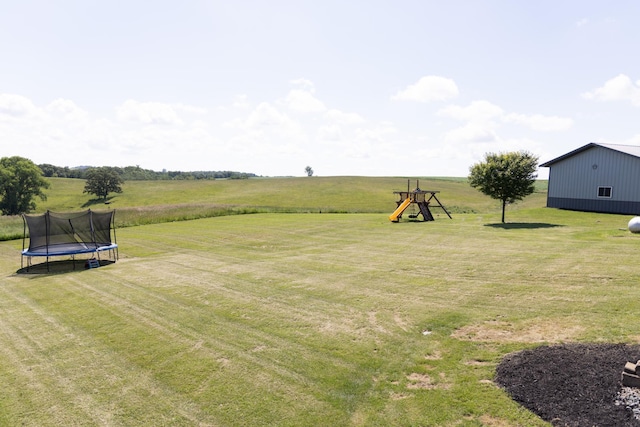 66182 310th Ave, Lake City, MN 55041 - view of grassy yard featuring a trampoline