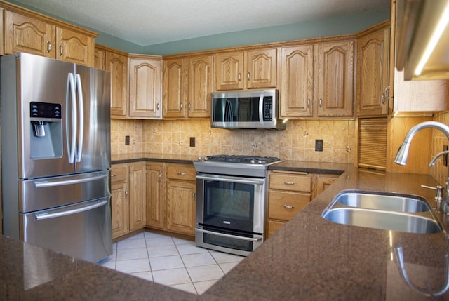66182 310th Ave, Lake City, MN 55041 - kitchen with stainless steel appliances, light tile patterned floors, dark stone counters, tasteful backsplash, and brown cabinets