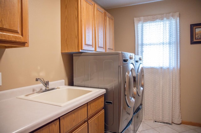 66182 310th Ave, Lake City, MN 55041 - washroom featuring cabinet space, washing machine and clothes dryer, and light tile patterned floors