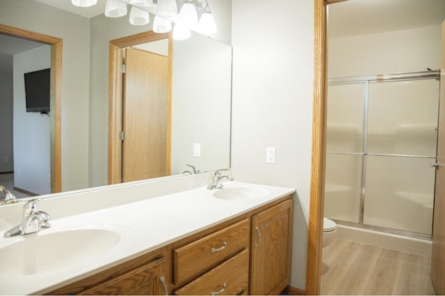 66182 310th Ave, Lake City, MN 55041 - full bathroom with double vanity, wood finished floors, and an enclosed shower