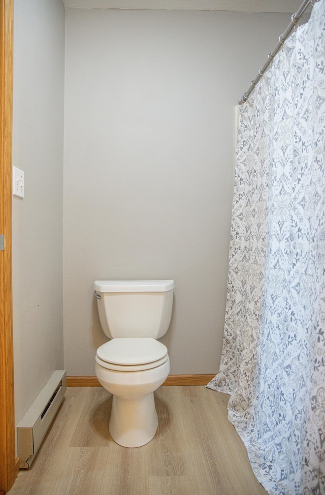 66182 310th Ave, Lake City, MN 55041 - bathroom with a baseboard radiator, wood finished floors, and a shower with curtain