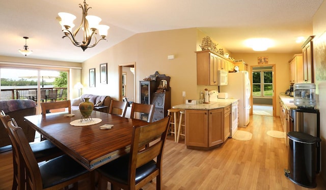 410 Pospeck Ln, Hoyt Lakes, MN 55750 - dining room with light wood finished floors, healthy amount of natural light, lofted ceiling, and a chandelier