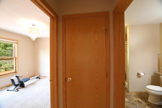 410 Pospeck Ln, Hoyt Lakes, MN 55750 - hallway featuring a textured ceiling and baseboards