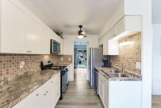 12190 Drake St NW, Coon Rapids, MN 55448 - kitchen featuring stainless steel appliances, ceiling fan, light wood-type flooring, tasteful backsplash, and white cabinets