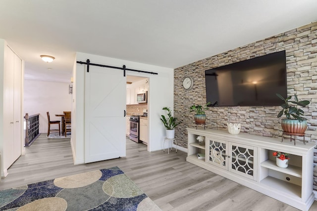 12190 Drake St NW, Coon Rapids, MN 55448 - living area featuring a barn door and light wood-style floors