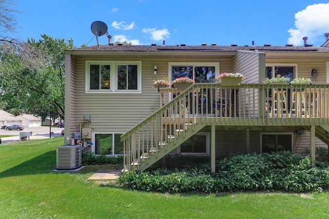 12190 Drake St NW, Coon Rapids, MN 55448 - rear view of property with stairs, a wooden deck, and a lawn