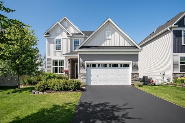 3702 112th Cir NE, Blaine, MN 55449 - craftsman-style house with board and batten siding, asphalt driveway, a front lawn, stone siding, and a garage