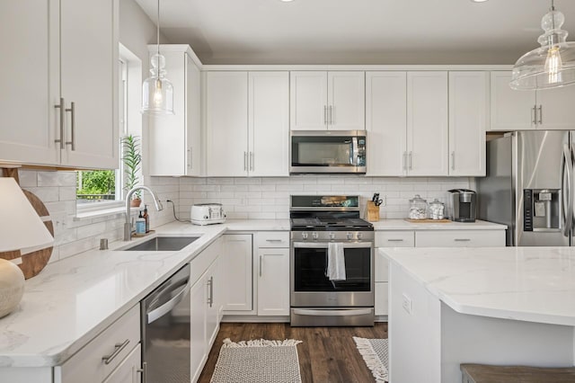 3702 112th Cir NE, Blaine, MN 55449 - kitchen with stainless steel appliances, dark wood-style flooring, light stone counters, and white cabinets