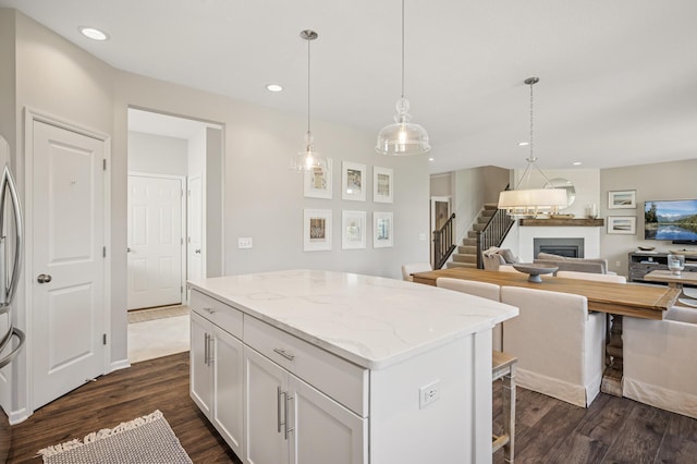 3702 112th Cir NE, Blaine, MN 55449 - kitchen featuring a fireplace, a center island, dark wood-style flooring, open floor plan, and recessed lighting