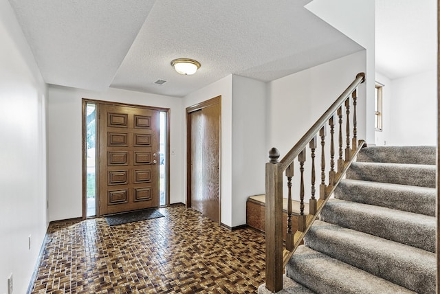 6925 Colorado Ave N, Brooklyn Park, MN 55429 - foyer entrance with stairs and a textured ceiling