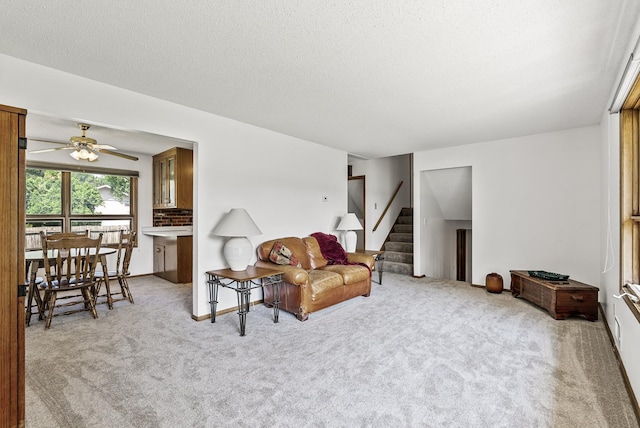 6925 Colorado Ave N, Brooklyn Park, MN 55429 - living room featuring carpet flooring, stairway, a ceiling fan, and a textured ceiling