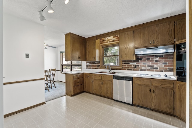 6925 Colorado Ave N, Brooklyn Park, MN 55429 - kitchen with stainless steel dishwasher, under cabinet range hood, light countertops, white cooktop, and black oven