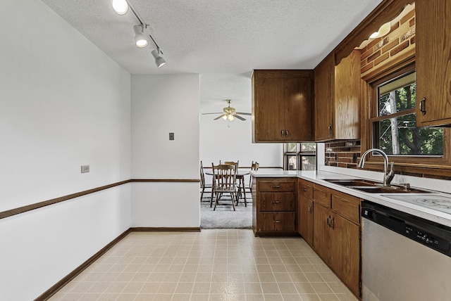 6925 Colorado Ave N, Brooklyn Park, MN 55429 - kitchen with stainless steel dishwasher, light countertops, a textured ceiling, ceiling fan, and rail lighting