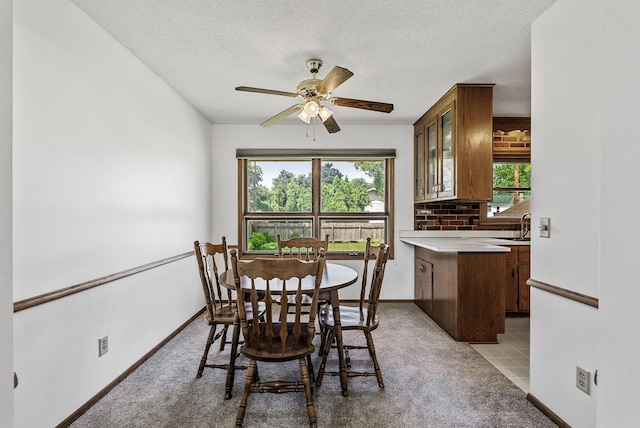 6925 Colorado Ave N, Brooklyn Park, MN 55429 - dining room with light carpet, a textured ceiling, and ceiling fan
