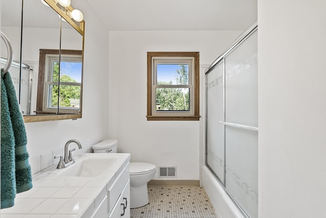 6925 Colorado Ave N, Brooklyn Park, MN 55429 - bathroom featuring vanity, enclosed tub / shower combo, and tile patterned flooring