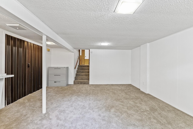 6925 Colorado Ave N, Brooklyn Park, MN 55429 - finished below grade area with carpet, stairway, and a textured ceiling