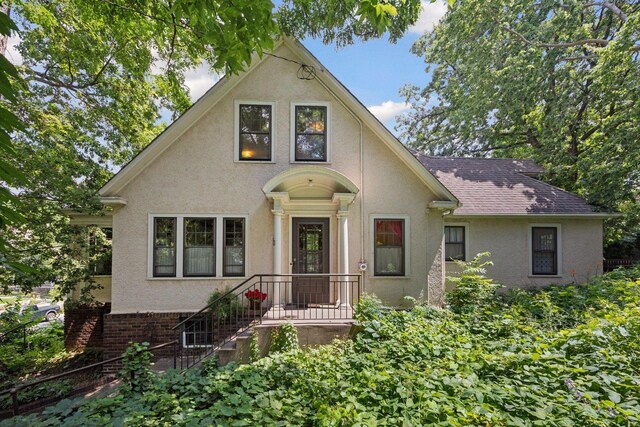 73 Arthur Ave SE, Minneapolis, MN 55414 - view of front of house with stucco siding and a shingled roof